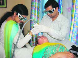 A patient undergoes Non-Ablative Erbiyium Glass Laser treatment at a camp in Dehradun on Sunday.