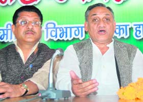 Congress candidate from Tehri Garhwal Vijay Bahuguna (right) talks to mediapersons in Dehradun