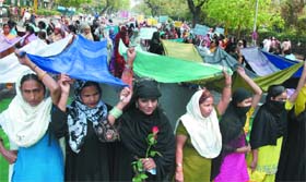 Women activists of the All India Bunkar Sangh demand political party status for their organisation at Parliament Street in New Delhi