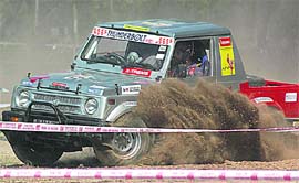 A participant at the Autocross, SJOBA Sub-Himalayan Open Rally-2009, at Circus Ground-17,Chandigarh, seems to be daunting his fellow contestants as he surges ahead in full mirth. 