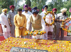 Chief Minister Parkash Singh Badal paying floral tributes to Shaheed Bhagat Singh, Rajguru and Sukhdev at Hussainiwala on Monday.