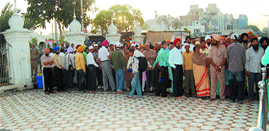 Devotees stranded near the Langar Hall during the visit of Prime Minister Manmohan Singh at Golden Temple in Amritsar  on Tuesday.
