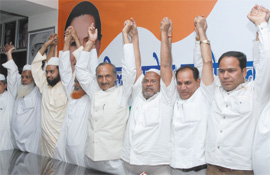 Furkan Kureshi (extreme right) of the BJP joins the Congress with his supporters at the DPCC office in New Delhi on Tuesday.