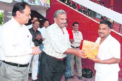 Civil Secretariat captain receives the award at the ONGC Inter-Institutional Cricket Tournament in Dehradun on Tuesday. 