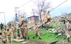 Commandos of the Jammu and Kashmir police exhibit their skills during the disaster management programme organised by UNDP at Manigam in Ganderbal. 