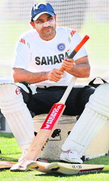 Virender Sehwag works on one of his bats during a training session in Napier.