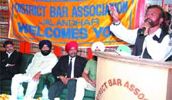 SAD-BJP candidate singer-turned -politician Hans Raj Hans addresses a gathering as SAD MLA Sarabjit Makkar and DBA chief Balwinderjit Singh Lucky look on, in the District Bar Association office in Jalandhar