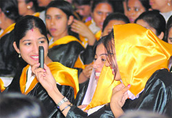 Students take their pictures during the convocation at Ramgarhia Girls College in Ludhiana on Thursday.