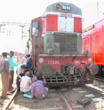 Technicians restore the rail track after the engine of a goods train derailed at the Jalandhar railway station