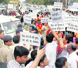  Parents of schoolchildren block traffic in protest against the fee hike by private schools in Gurgaon on Friday.