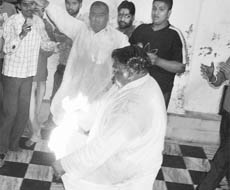 Ramesh Kumar Pappu sets himself on fire at Kali Mata temple in Patiala on Saturday.