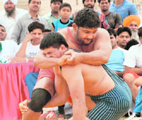 Grapplers in action during first Punjab Kesari Wrestling Championship at Dushera ground in Mohali on Saturday.
