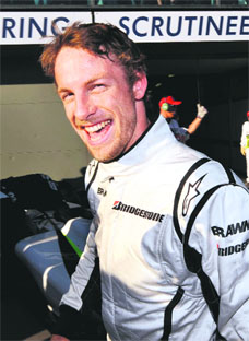 Brawn driver Jenson Button celebrates after claiming pole position in qualifying for the Australian Grand Prix in Melbourne on Saturday.  AFP