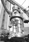 Japanese artist Kenji Yanobe (bottom L) displays his creation, a 7.2m (23.6 ft) tall aluminium robot called the Giant Torayan during Roppongi Art Night in Tokyo on Friday. The Giant Torayan can shoot fire from its mouth as well as move its head, eyes and arms by air actuators.