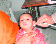 A child being examined at a free medical check-up camp held in the Gopal Bagh area of Kangra on Sunday.