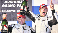 Brawn GP driver Rubens Barichello (L) and Jenson Button celebrate on the podium at the Australian GP on Sunday.