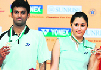 Diju Valiyaveetil (L) and Jwala Gutta pose with their medals on Sunday.