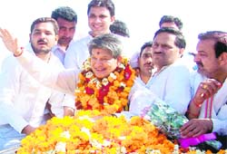 Harish Rawat waves during his road show in Haridwar 