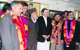 Chief Minister Omar Abdullah poses with leaders who returned to the NC fold in Srinagar on Monday. 