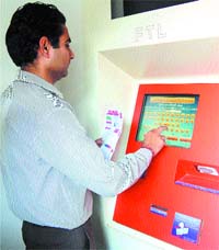 An operator pays bill at a bill collection machine in Amritsar