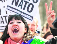 Anti-NATO protesters shout slogans as they gather for a demonstration during the International Conference in Afghanistan on Tuesday.