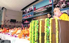 The Dalai Lama addresses a gathering at the inauguration of Yogpeeth Patanjali in Haridwar on Wednesday. Also seen in the picture is Baba Ramdev. 