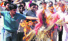Gramin Yuva Sena activists burn an effigy of UP Chief Minister Mayawati in Karnal on Wednesday.