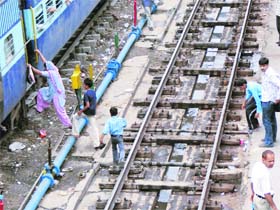 Unmindful of the lurking danger, passengers cross the railway track to board a train in Ludhiana