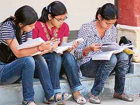 Girls go through their notes during the first exam of Panjab University