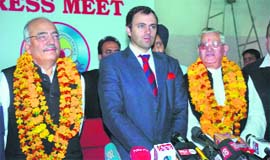 Chief Minister Omar Abdullah welcomes Gobind Ram Sharma (right) and Talib Hussan into the NC fold in Jammu on Thursday. 