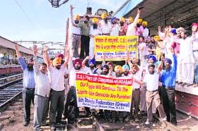 Activists of the Sikh Students’ Federation stage a dharna in front of a train at railway station in Ludhiana
