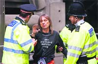 French climber Alain Robert, also known as Spiderman is arrested by police after climbing the Lloyds Building in a protest to raise awareness on climate change in London