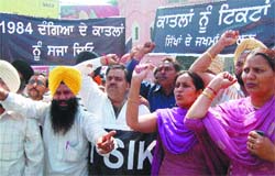 Activists of the SAD protest against Congress president Sonia Gandhi and AICC general secretary Rahul Gandhi in Amritsar on Friday.