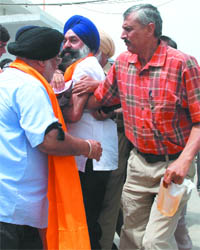 A Delhi policeman seizes kerosene from Sikh activists at the Bangla Sahib Gurudwara in New Delhi on Friday.