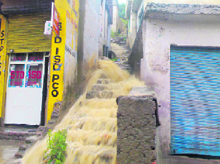 Water gushes out of a broken drain in Rajouri.