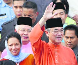 Malaysias formar Prime Minister Abdullah Ahmad Badawi waves as his wife Jane Abdullah, and new Prime Minister Najib Razak look on at Prime Minister office in Putrajaya on Friday. 