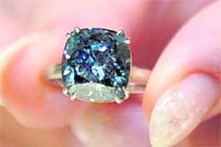 A model shows a blue diamond from the Cullinan mine weighing 7.03 carats that will be auctioned in Geneva on April 8 with a pre-sale esimate of $5.8-8.5 million, at a preview of Sotheby's Spring Sales in Hong Kong