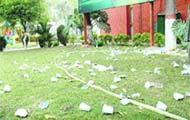 Glass and paper plates littered across a lawn  at Chandigarh Press Club 