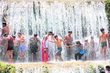 Tourists have fun at Sahastradhara near Dehradun even as mercury crossed the 30-degree mark on Saturday.
