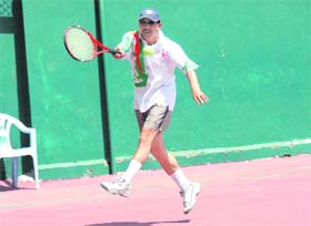 A player fires a return during the Uttarakhand State Tennis Championship in Dehradun