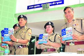 Uttarakhand DGP Subhash Joshi (left) releases a souvenir on Police Raising Day
