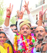 Narinder Thakur greeting his supporters on reaching Hamirpur during the road show on Saturday.