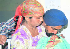 Father kisses his son, who was restored to the couple in Ludhiana on Saturday.