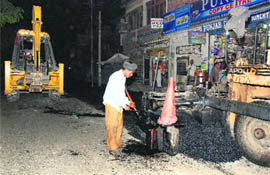 Road being recarpeted in one of the areas in Ludhiana during night hours.