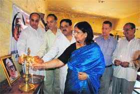 Members of the Akhil Bhartiya Rachnatmak Samaj light a lamp to celebrate 102nd birth anniversary of Babu Jagjivan Ram in Jammu