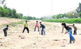 CRICKET FEVER: The dry bed of Sidhwan Canal provides a perfect ground for cricket enthusiasts in Ludhiana