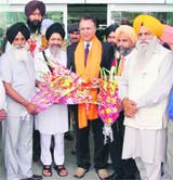 The SGPC secretary and members welcome Daljit Singh of Akal Airlines at the Amritsar international airport on Sunday. 