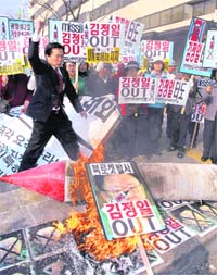 South Korean protesters burn placards bearing pictures of North Korean leader Kim Jong II and mock missile during a rally near the U.S. Embassy in Seoul on Sunday. 