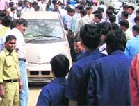Curious onlookers gather in front of the Tata showroom on the Delhi-Dehradun National Highway in Roorkee on Monday