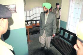 Suspended additional director-general of police BS Thind being produced in court at the DC office at Shimla